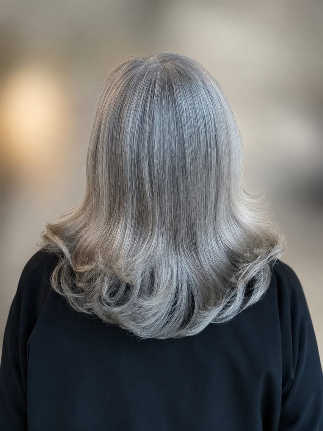Long silver hair with soft curls — a finished French grey blend