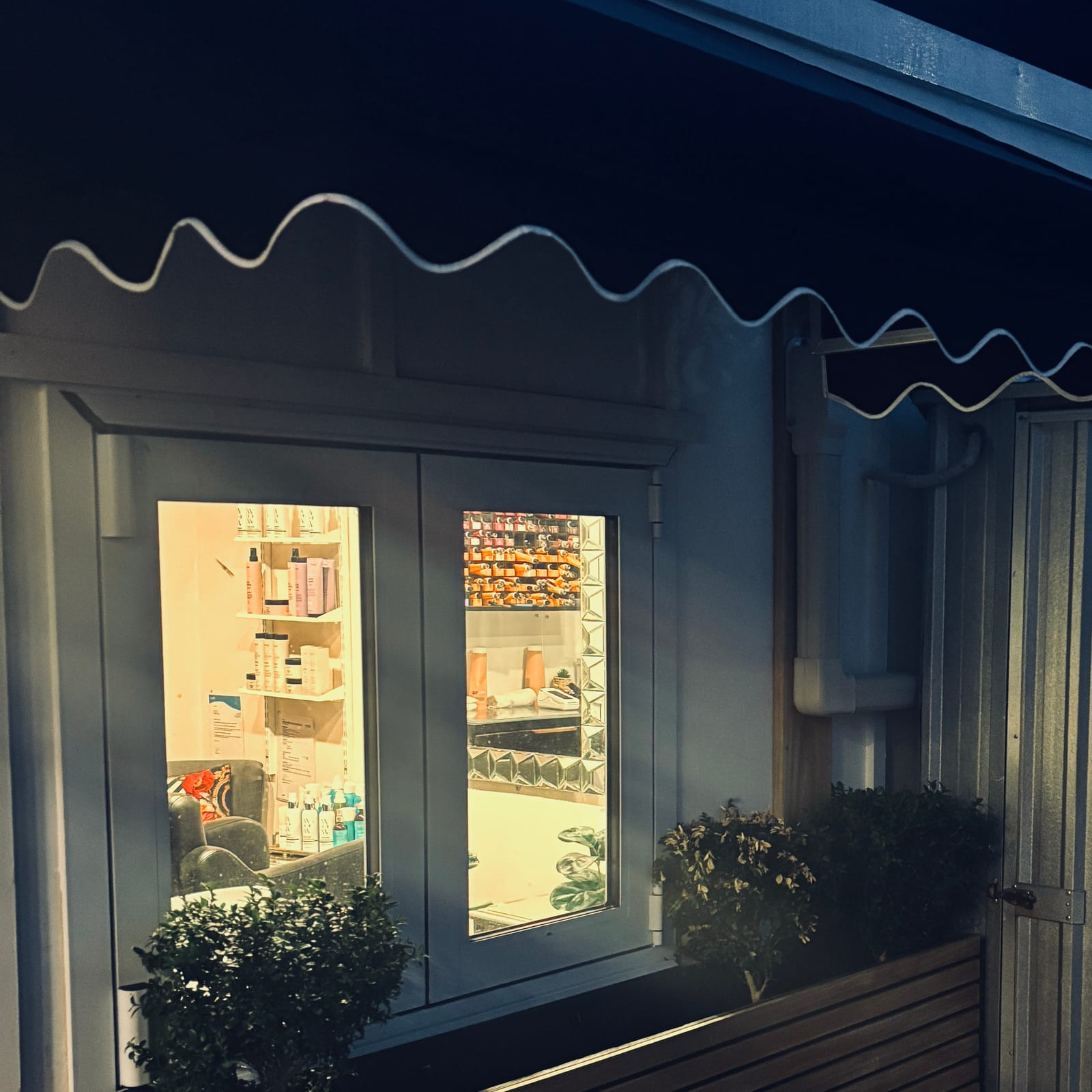 The studio's awning and window, glowing at dusk on Muritai Road